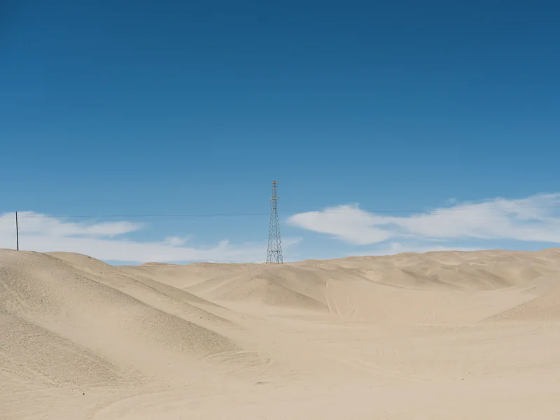 Remote border surveillance tower overlooking terrain where radar cues optical identification