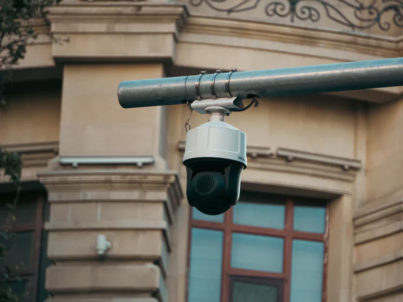 A pan-tilt-zoom surveillance camera mounted on a horizontal support