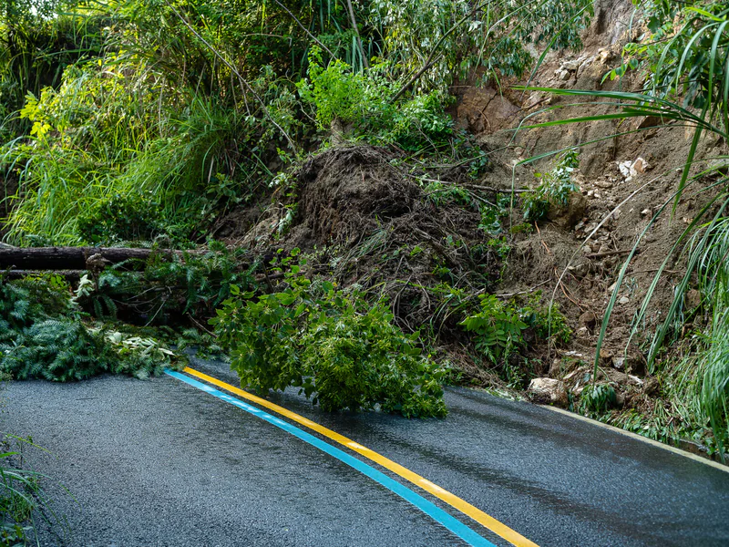 Closed mountain road illustrating the protective-action and reopening decisions supported by debris-flow monitoring