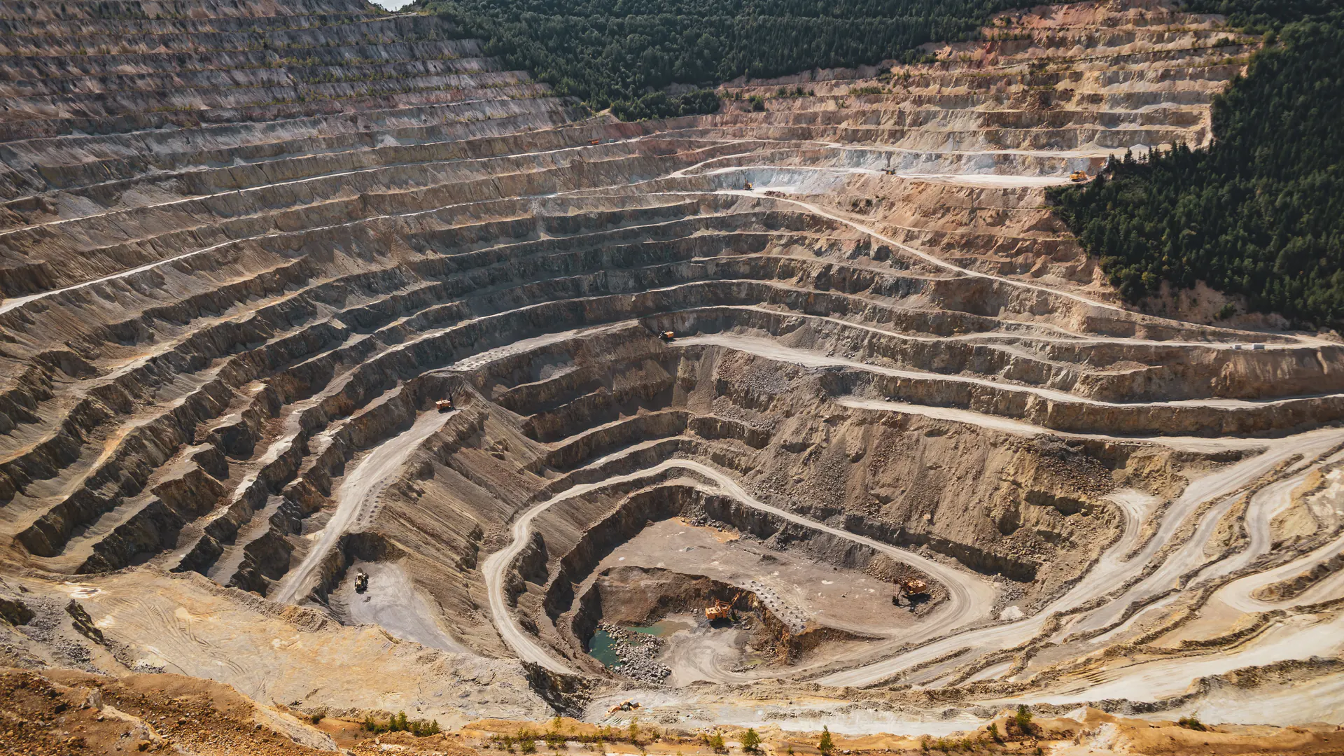 Open-pit mine highwall where radar coverage geometry and changing benches determine installed cost