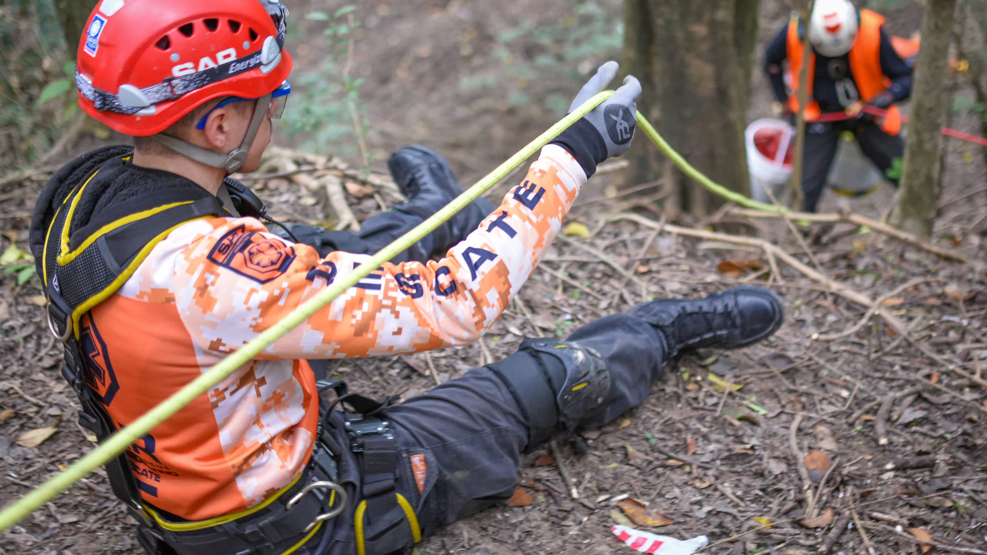 Search and rescue field team preparing a drone near rugged terrain for a time-critical mission